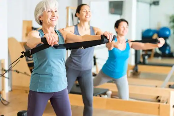 older woman doing weight training Horsham and resistance in the gym to tone upper arms