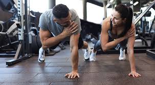 Image of man and woman doing Cardio Horsham to tone their arms. 